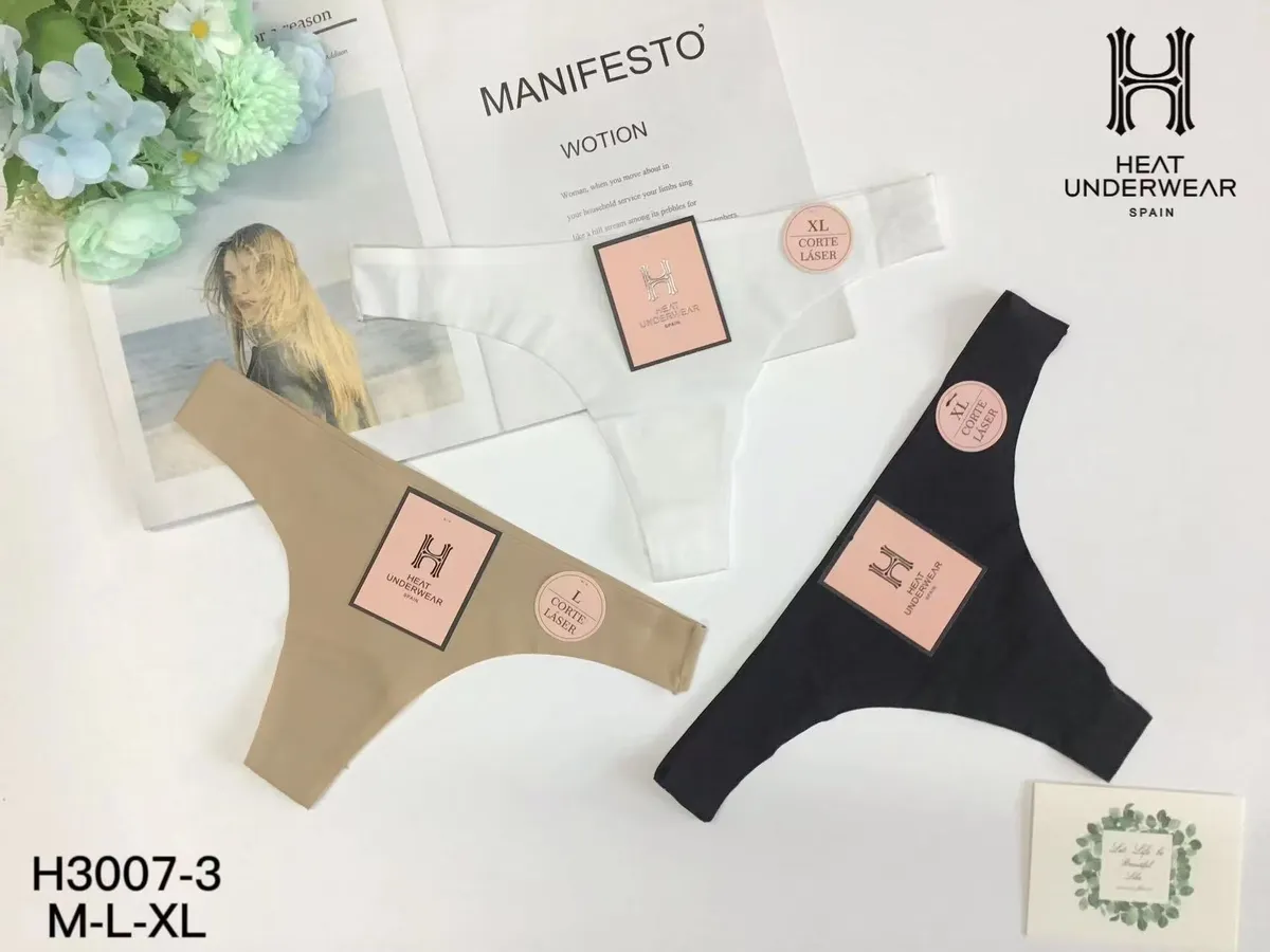 Trzy pary damskich majtek laserowo ciętych w kolorach beżowym, białym i czarnym z etykietami Heat Underwear