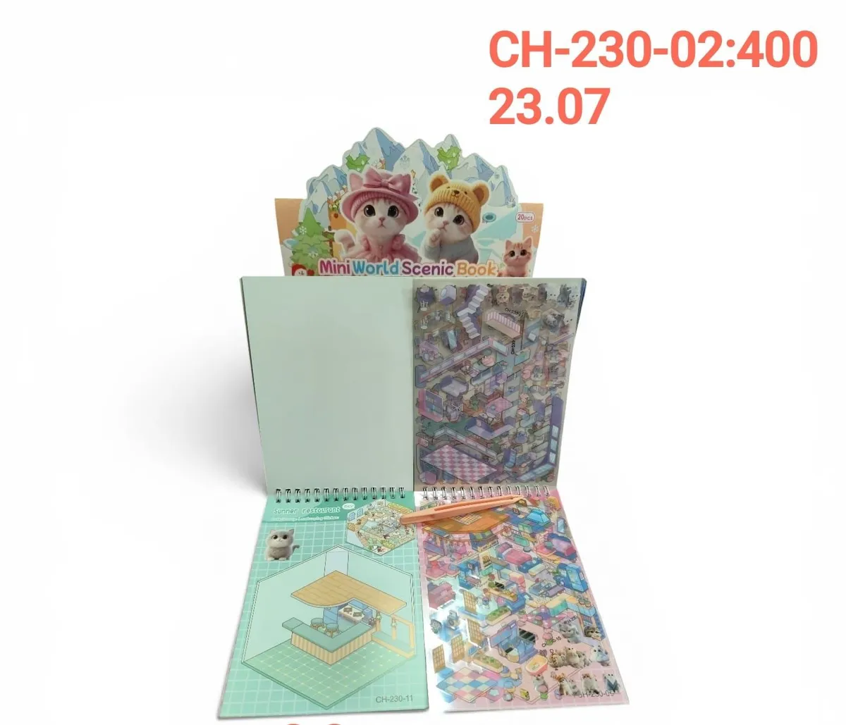Otwarty spiralny notes z naklejkami przedstawiający kolorowe wnętrza z kotkami, karty 3D, drewniany patyczek i kartonik z mot