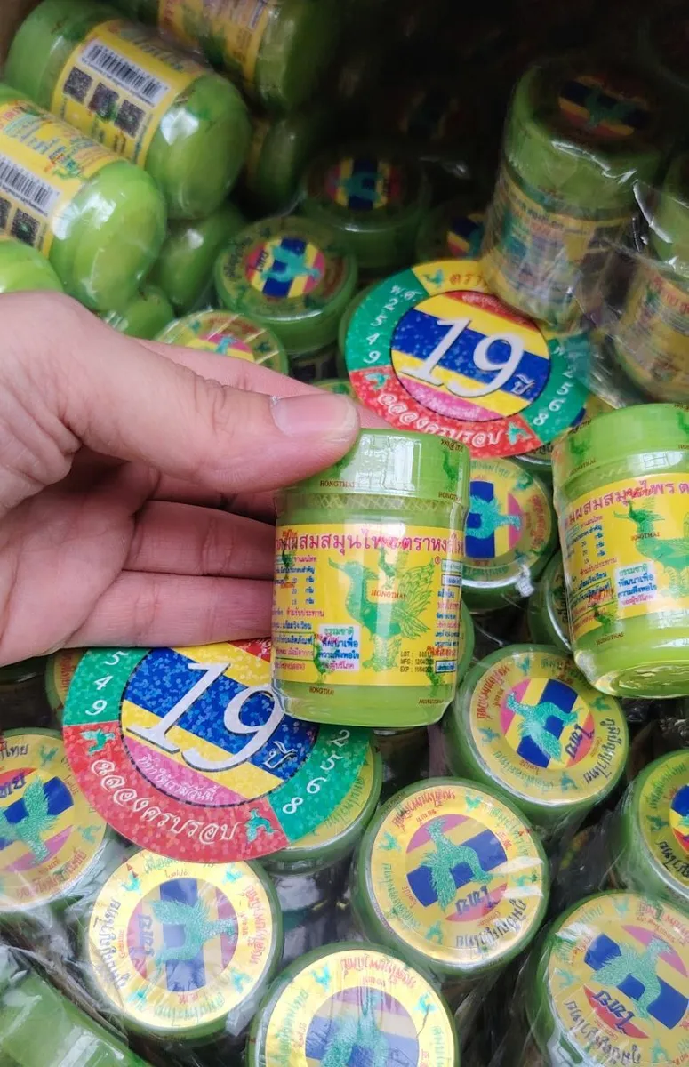 zielone plastikowe słoiczki kremu tajskiego z kolorową etykietą i grafiką kolibra