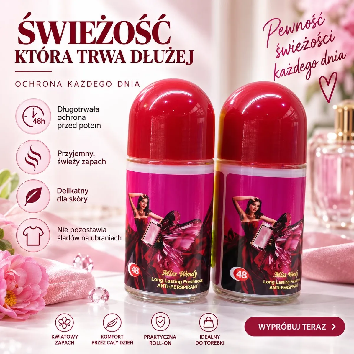 Dwa różowe dezodoranty Labomba Miss Wendy roll-on z czerwonymi korkami na tle kwiatów i kosmetyków