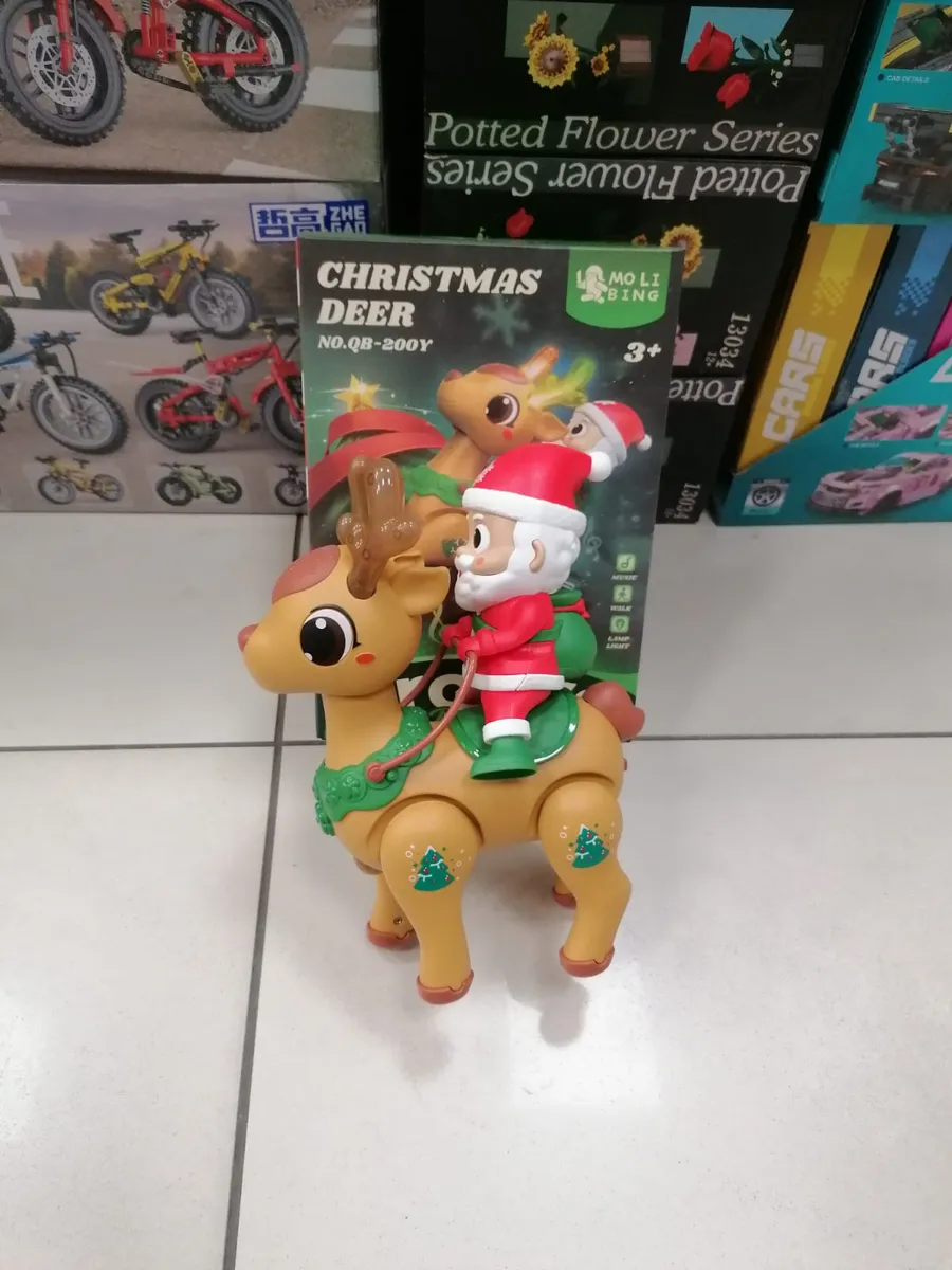 Figurka renifera z Mikołajem w czerwonym stroju na grzbiecie, opakowanie z napisem Christmas Deer
