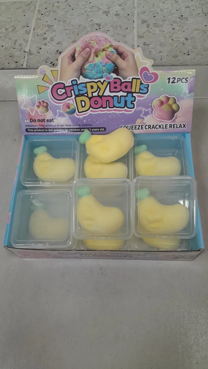 Żółta gniotka antystresowa w kształcie banana z zielonym ogonkiem w plastikowym pudełku, 12 sztuk w opakowaniu zbiorczym